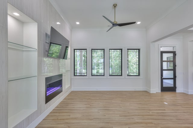 unfurnished living room featuring light wood-type flooring, crown molding, and ceiling fan