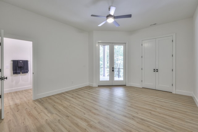 unfurnished bedroom featuring light hardwood / wood-style flooring, access to outside, ceiling fan, a closet, and french doors