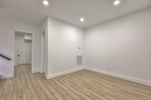 spare room with light hardwood / wood-style flooring