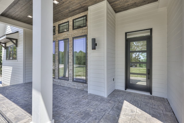 view of exterior entry featuring a porch