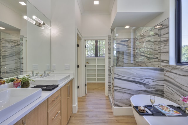 bathroom with vanity, wood-type flooring, and independent shower and bath