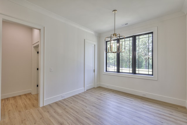 unfurnished dining area with a wealth of natural light, a notable chandelier, and light hardwood / wood-style flooring