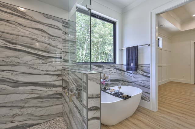 bathroom with ornamental molding, hardwood / wood-style floors, and separate shower and tub