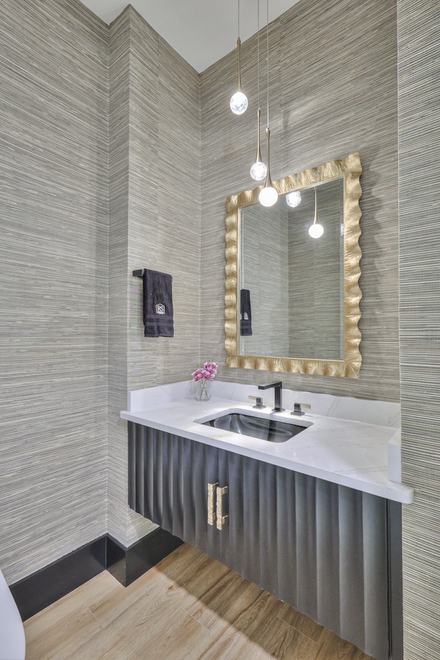 bathroom featuring vanity and tile walls