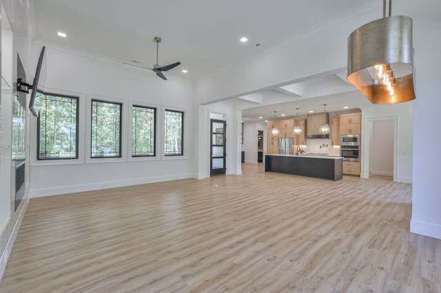 unfurnished living room featuring ceiling fan and light wood-type flooring