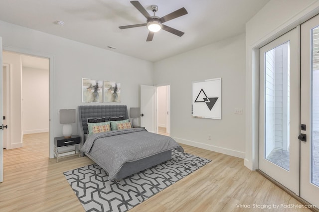 bedroom featuring light hardwood / wood-style flooring, ceiling fan, and access to outside