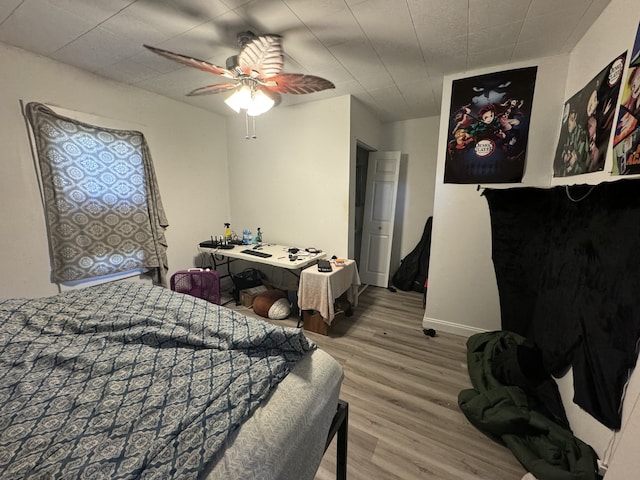 bedroom featuring hardwood / wood-style floors and ceiling fan