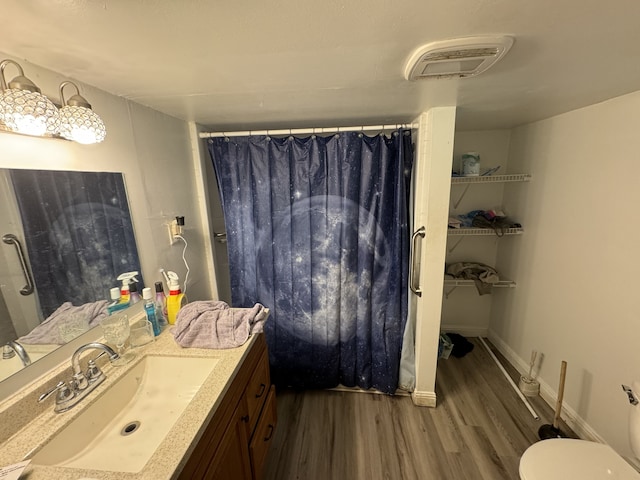 bathroom featuring a shower with curtain, vanity, toilet, and wood-type flooring