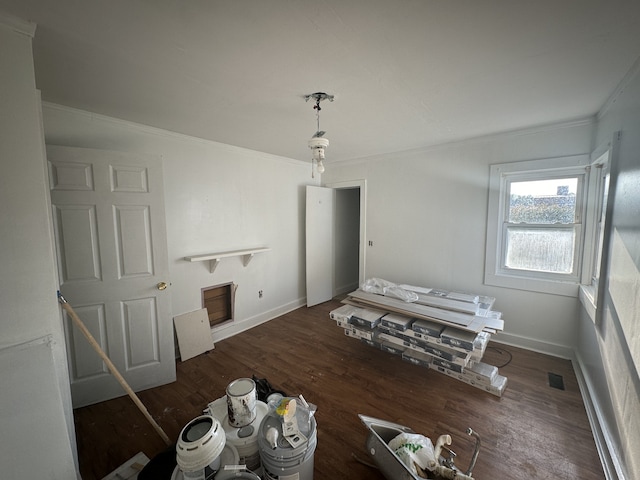 interior space with ornamental molding and dark hardwood / wood-style flooring