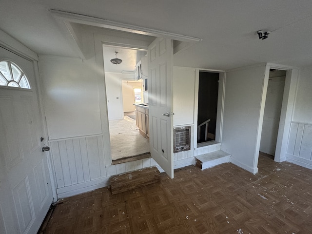 spare room with dark parquet floors and heating unit