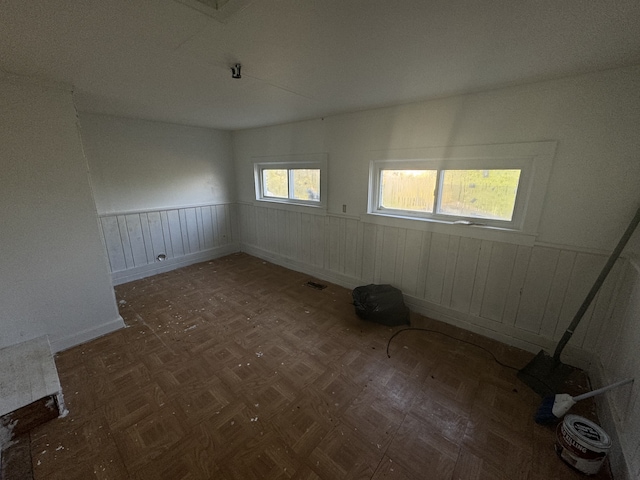 spare room with dark parquet flooring