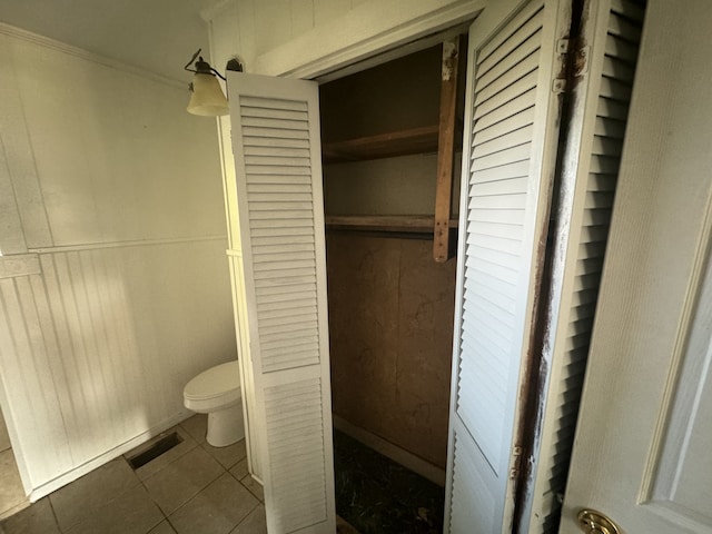 bathroom with toilet and tile patterned floors