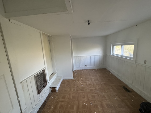 interior space with dark parquet flooring and a fireplace