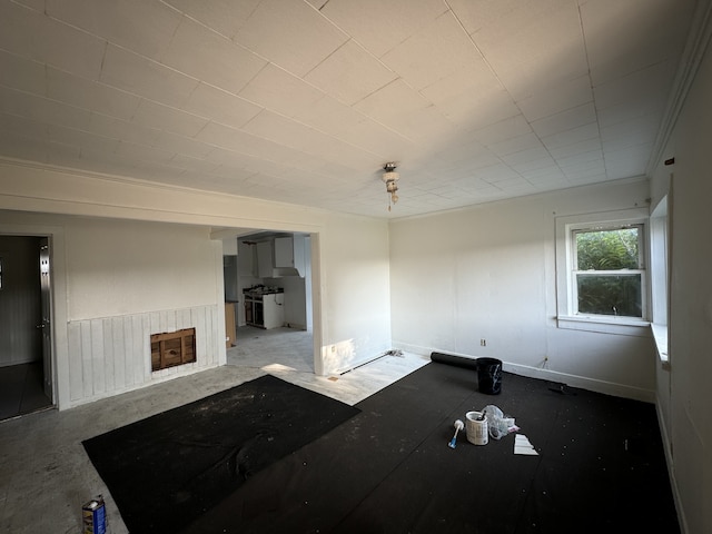 unfurnished living room featuring concrete flooring and a fireplace