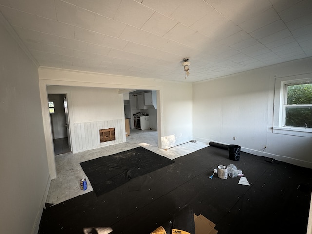 living room featuring concrete flooring and a fireplace