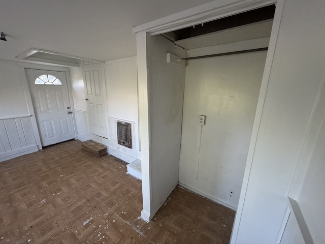 interior space featuring dark parquet floors and heating unit