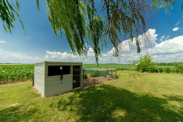 view of outdoor structure featuring a yard and a rural view