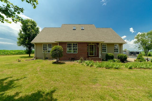 back of property featuring a lawn