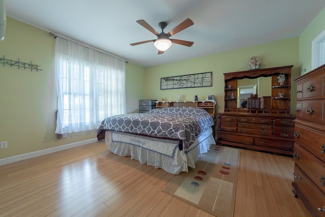 bedroom with light wood-type flooring and ceiling fan