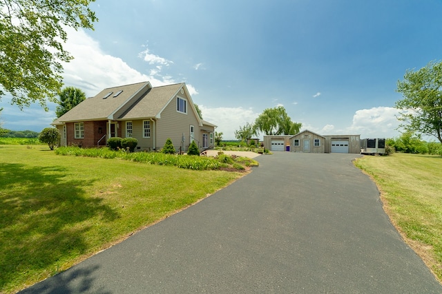 view of front of home featuring a garage and a front lawn