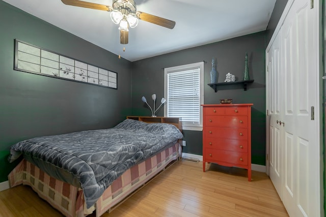 bedroom with a closet, ceiling fan, and light hardwood / wood-style floors