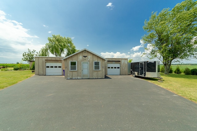 manufactured / mobile home featuring a garage and a front lawn