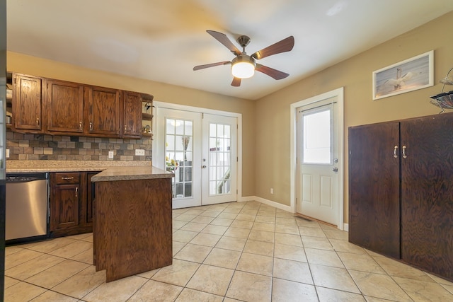 kitchen with light tile patterned floors, french doors, ceiling fan, tasteful backsplash, and stainless steel dishwasher