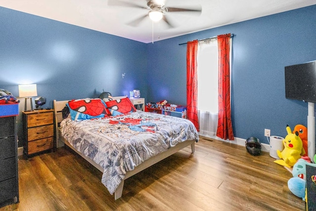 bedroom with dark hardwood / wood-style flooring and ceiling fan