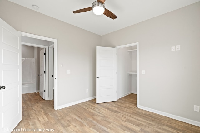 unfurnished bedroom featuring ceiling fan, a closet, and light hardwood / wood-style flooring