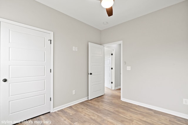 unfurnished bedroom featuring ceiling fan and light wood-type flooring