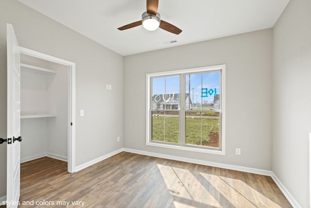 unfurnished room featuring hardwood / wood-style floors and ceiling fan