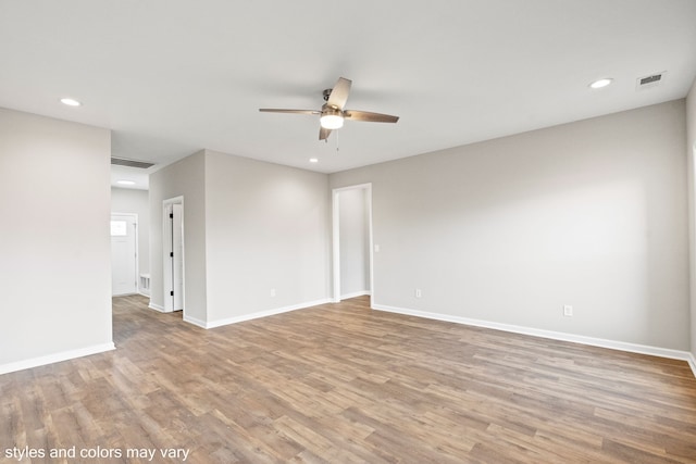 empty room featuring ceiling fan and hardwood / wood-style floors