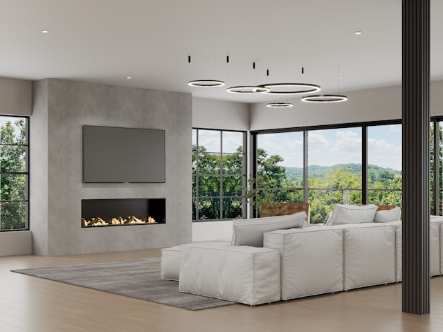 living room with a fireplace, a healthy amount of sunlight, and light hardwood / wood-style floors