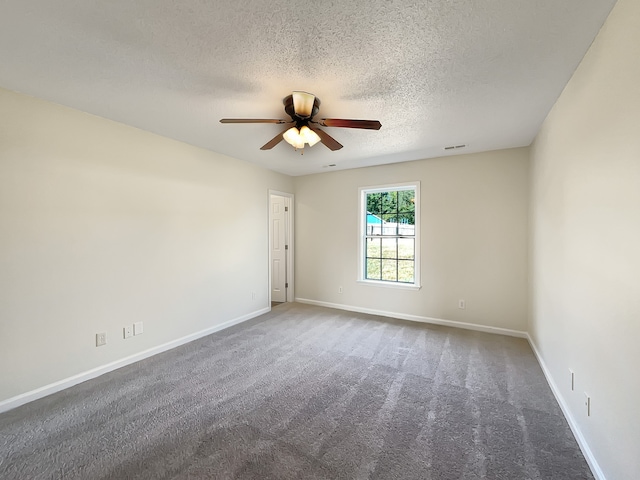 empty room featuring ceiling fan, carpet, and a textured ceiling