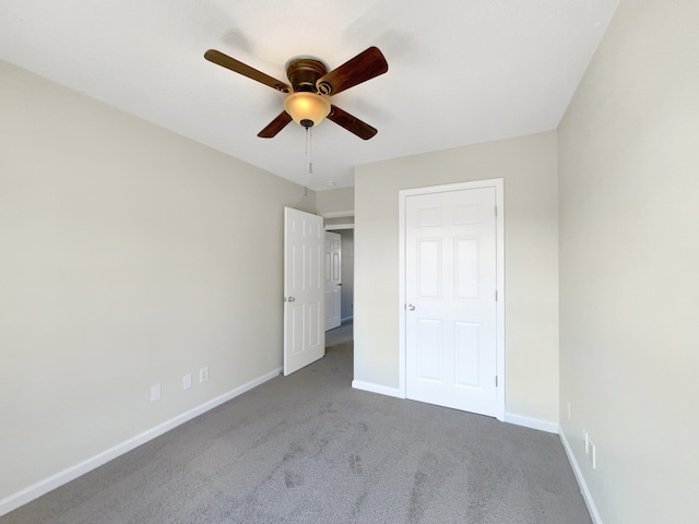 unfurnished bedroom featuring ceiling fan and carpet