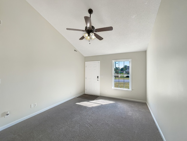 carpeted empty room with lofted ceiling, ceiling fan, and a textured ceiling