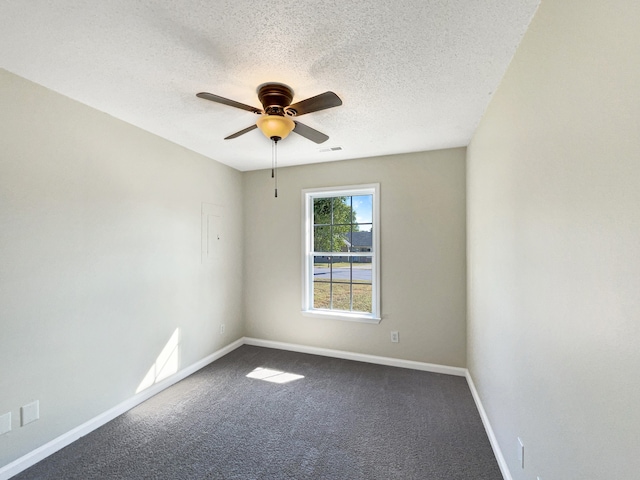 unfurnished room featuring a textured ceiling, ceiling fan, and carpet