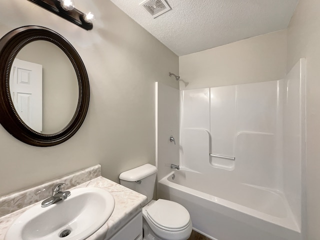 full bathroom with a textured ceiling, vanity, toilet, and shower / washtub combination