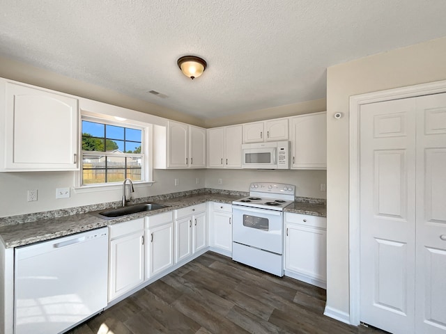 kitchen with dark wood-type flooring, sink, white appliances, and white cabinets