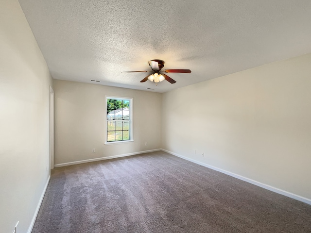 empty room with ceiling fan, a textured ceiling, and carpet floors