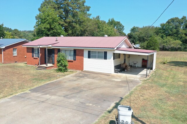 ranch-style home with a front yard and a carport