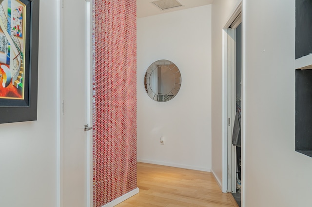 corridor with light hardwood / wood-style floors