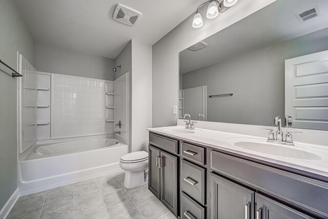 full bathroom featuring toilet, vanity, tile patterned flooring, and  shower combination