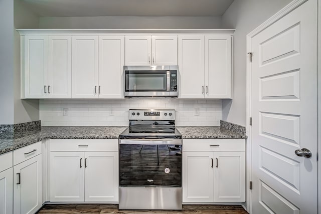 kitchen with white cabinetry, appliances with stainless steel finishes, and stone countertops