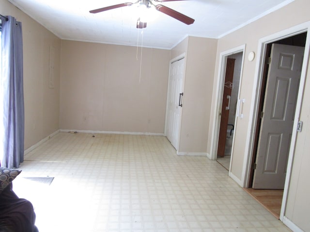 empty room with ceiling fan and crown molding