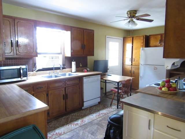 kitchen with ceiling fan, decorative backsplash, white appliances, and sink