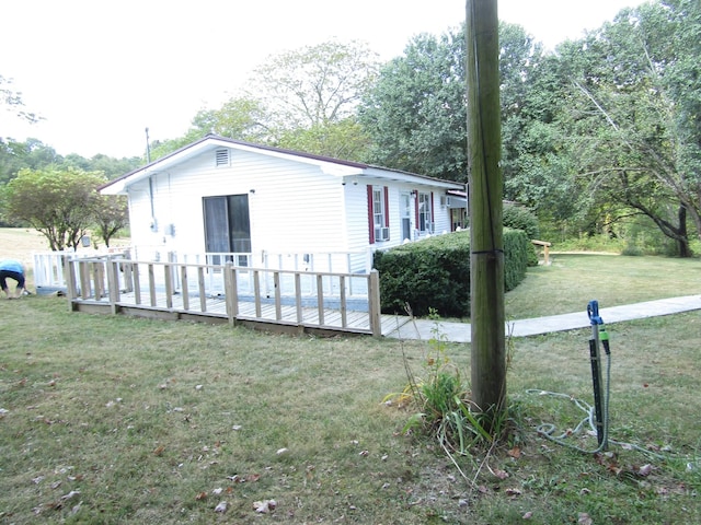 view of side of property featuring a wooden deck and a yard