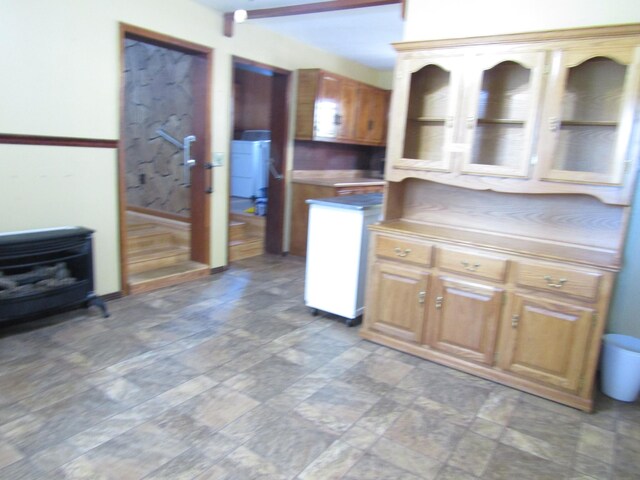 kitchen with washer / clothes dryer and a wood stove