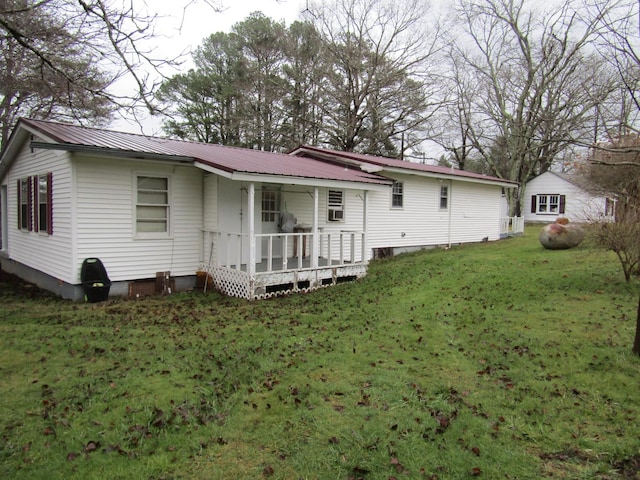 back of property featuring a yard