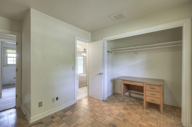 unfurnished bedroom with a closet, visible vents, and baseboards